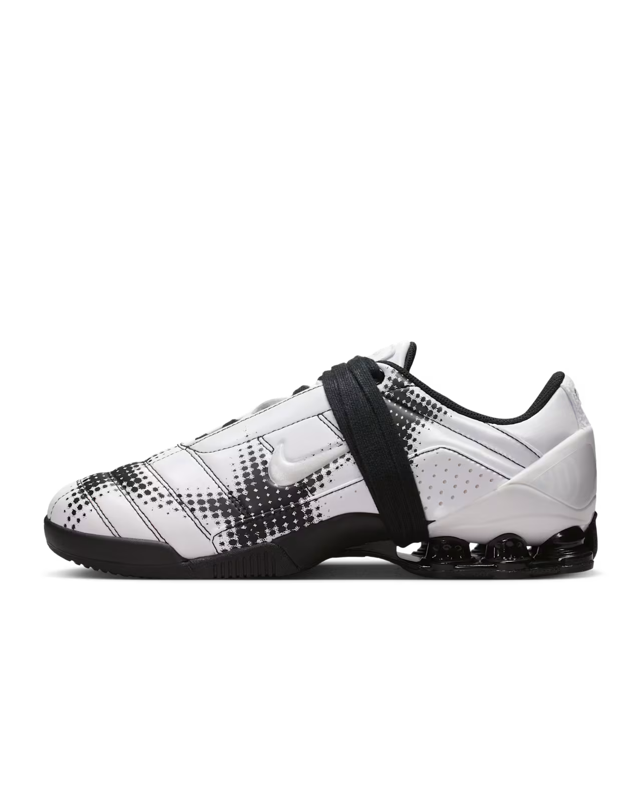 A white and black Machina Wearable Technology Total 90 Shox Magia athletic shoe featuring black pixelated stripes, a black sole, visible air cushioning, and a sleek black strap across the laces—ideal for anyone looking for stylish football shoes with advanced comfort.