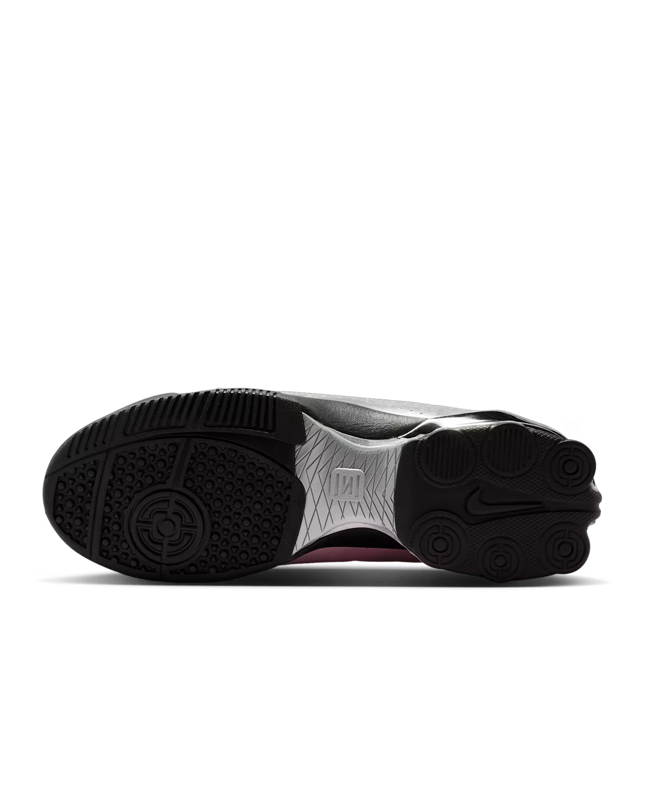 The image shows the black rubber outsole of the Machina Wearable Technology Total 90 Shox Magia x Forget me nots, featuring textured grip patterns, circular designs, a brand logo, and silver detailing in the center.