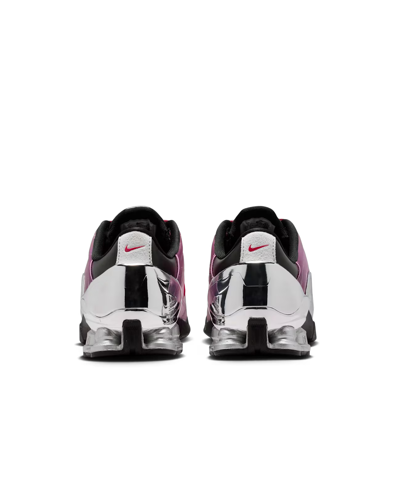 A pair of Total 90 Shox Magia x Forget me nots by Machina Wearable Technology, seen from the back, with shiny metallic silver heels, purple and black satin uppers, black soles, and small red logos on the heel tabs.
