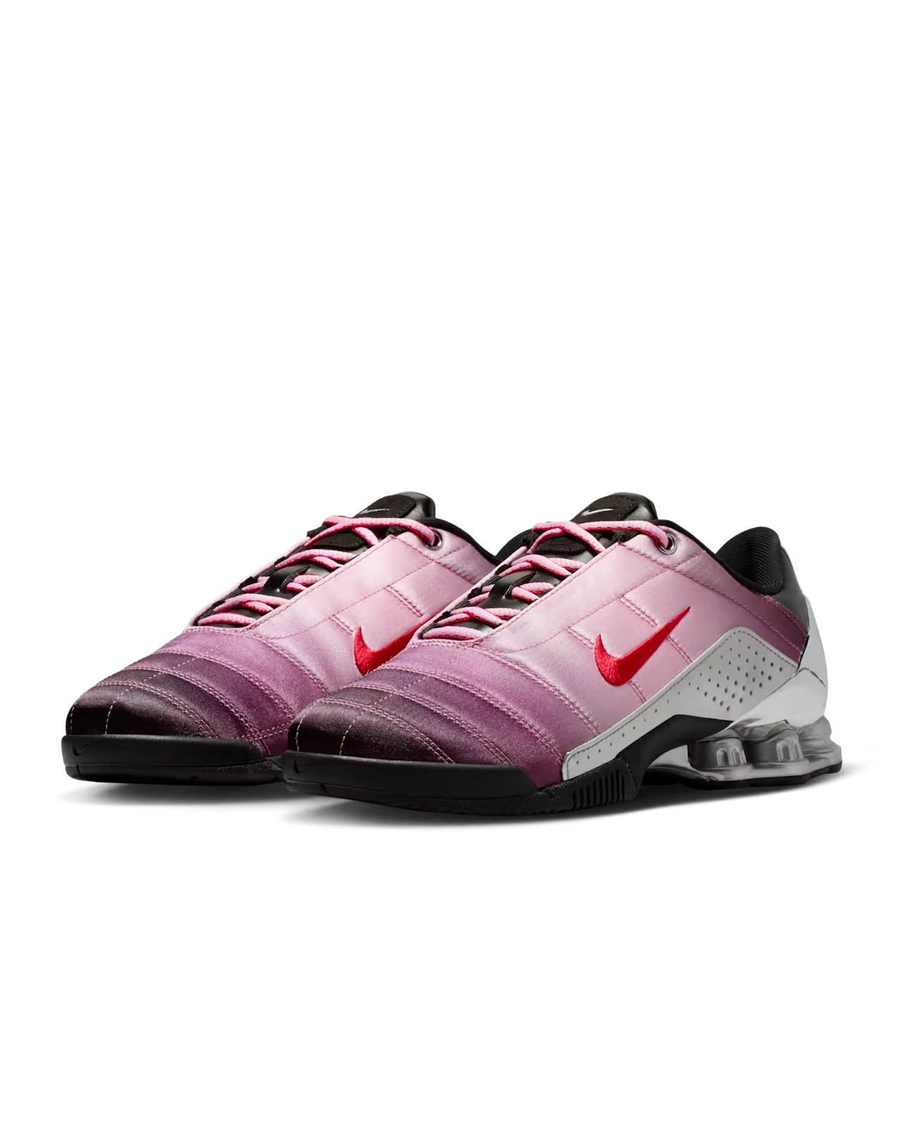 The Machina Wearable Technology Total 90 Shox Magia x Forget me nots features a gradient from purple toe to white heel, red swooshes, black laces, and signature Shox columns inspired by the original Nike Total 90 Shox Magia.