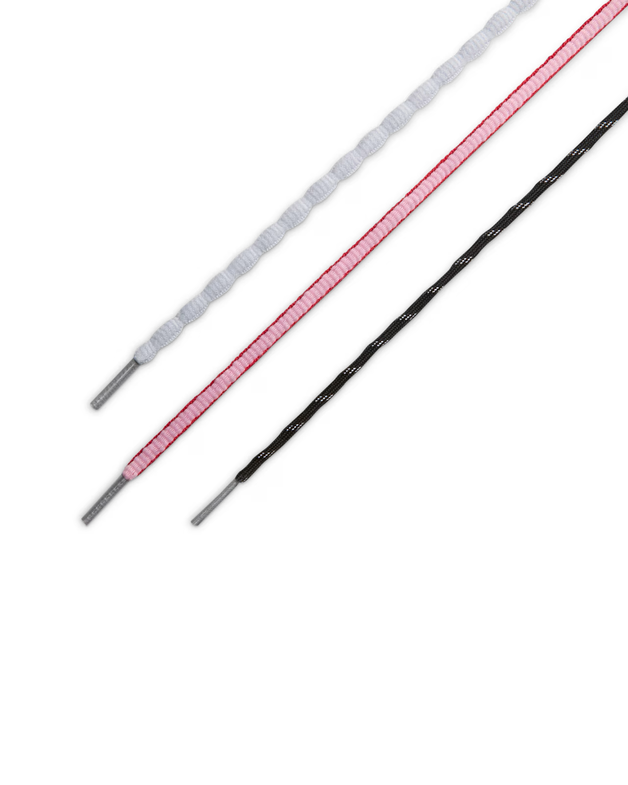 Three shoelaces—white, pink, and black with white stitching—are arranged diagonally on a white background, their metal aglets reflecting the premium finish of the Machina Wearable Technology Total 90 Shox Magia x Forget me nots.