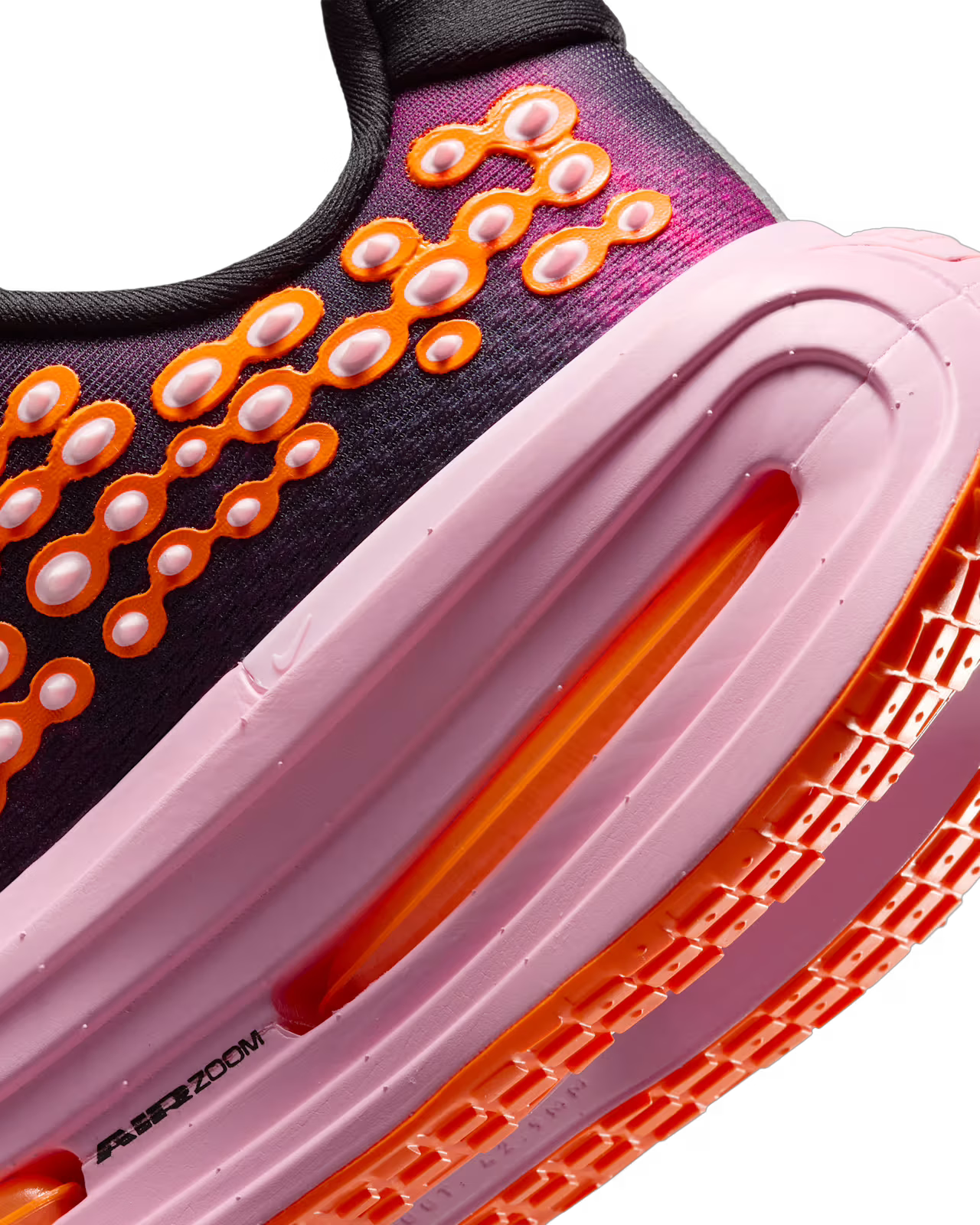 Close-up of The Nike Vomero Premium “Otaku Approved” sneaker by Machina Wearable Technology, featuring a pink midsole, orange-treaded outsole, and distinctive orange bubble details with visible Air Zoom branding. Engineered on the ZoomX platform for exceptional energy return—characteristic of maximum-cushion running shoes—the upper boasts black and purple tones highlighted by striking orange circular accents.