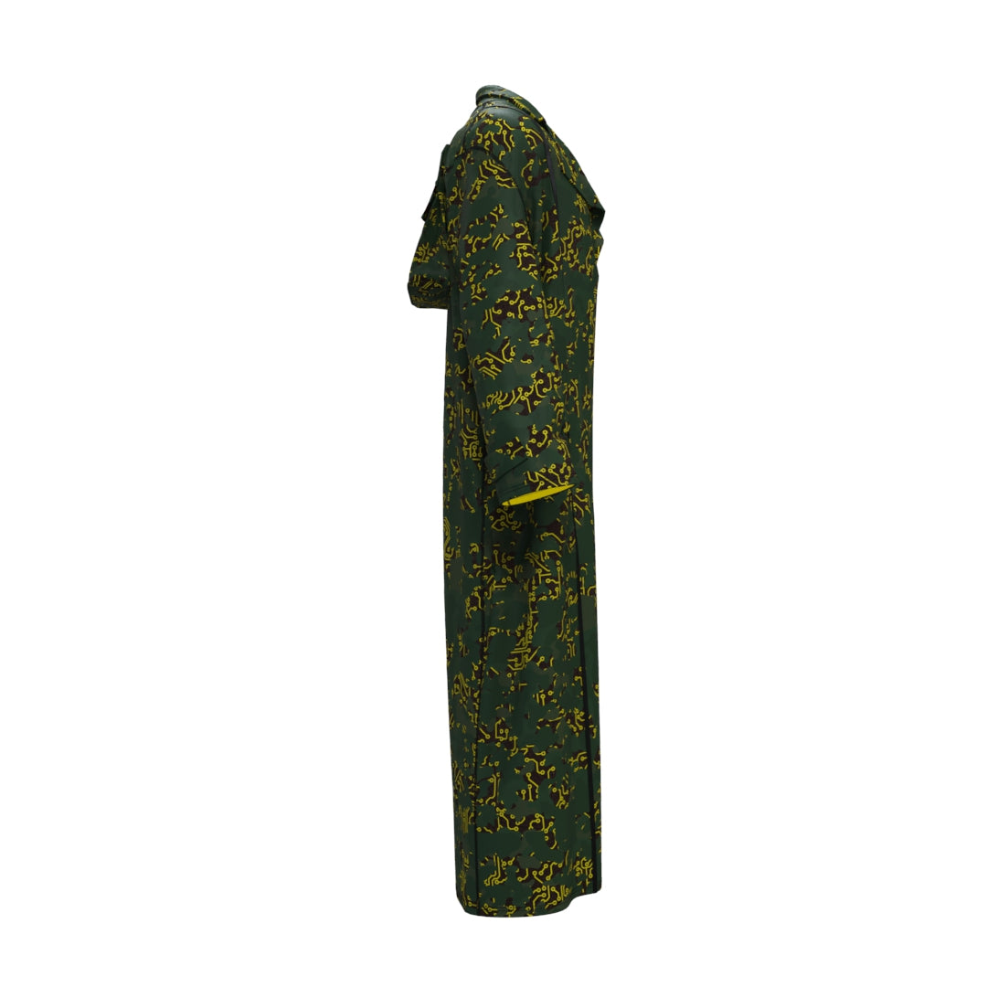 A side view of the Electric Yellow Sun Trench Coat by Machina - Wearable Technology, made from recycled fabric with striking electric yellow abstract patterns. This fashion tech marvel sports long sleeves and a standing collar, offering a loose fit that extends to the floor, seamlessly merging sustainability and style in an artful design.