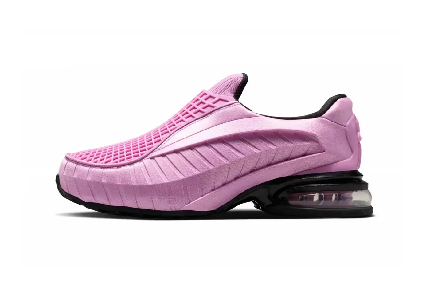 The Machina Wearable Technology Nike Air Max Dolce "Light Magenta" is a pink slip-on lifestyle sneaker with a textured upper, black accents, and a visible air cushion in the sole, displayed from a side view on a white background.
