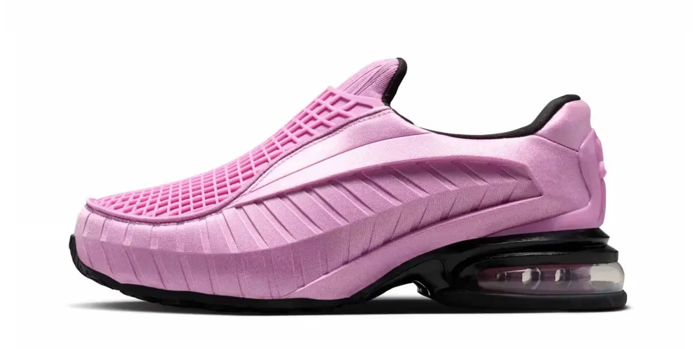 A Machina Wearable Technology Nike Air Max Dolce "Light Magenta" slip-on lifestyle sneaker featuring a textured light magenta upper, black sole, and a visible air cushion in the heel, displayed against a white background.