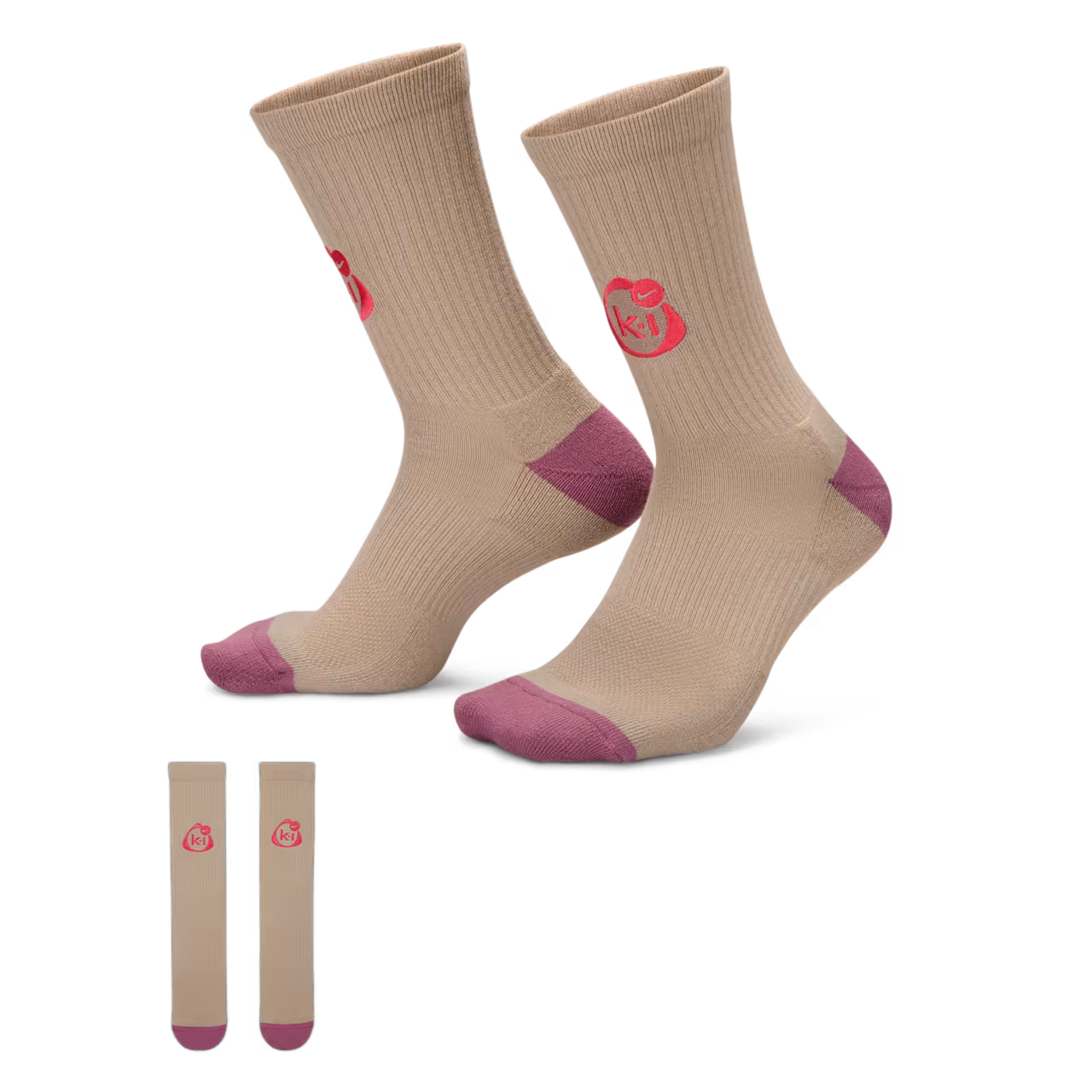 The Nike x Kids of Immigrants Elevated Crew Socks "Khaki" by Machina - Wearable Technology feature a beige design with pink toes, heels, and a pink k+l heart logo on the sides. The socks are shown upright, with both laid flat below.