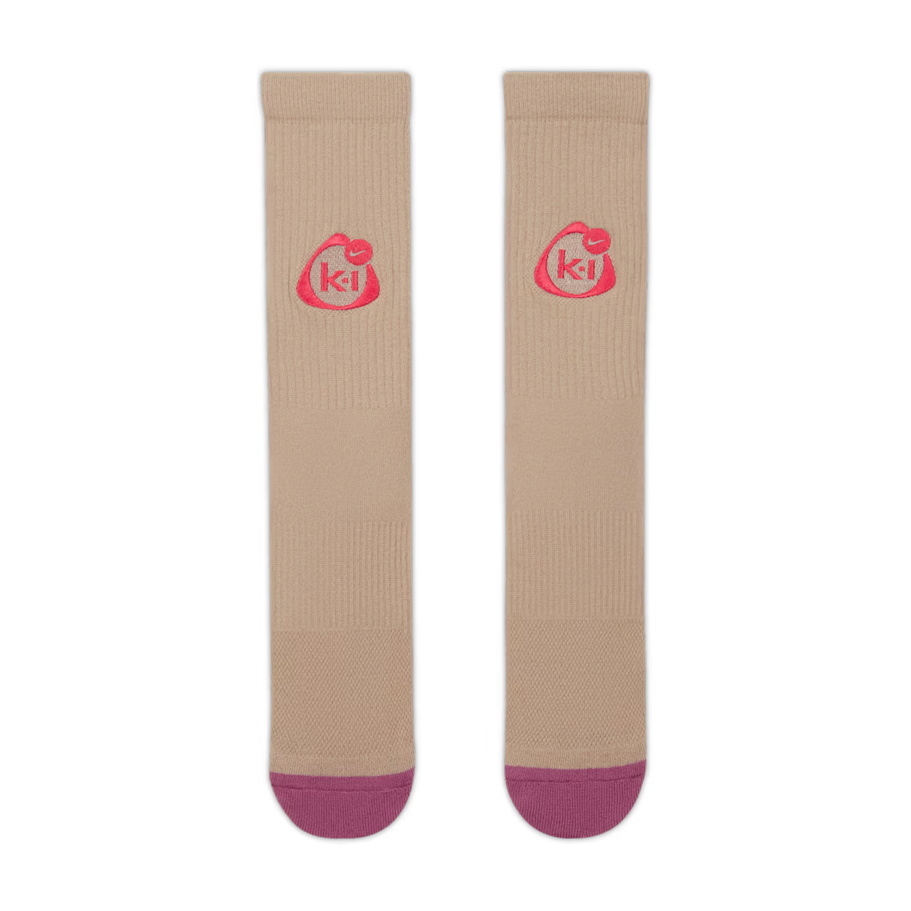 The Nike x Kids of Immigrants Elevated Crew Socks "Khaki" by Machina - Wearable Technology feature beige fabric, pink toe tips, and a circular pink "ki" logo on the upper part of each sock.