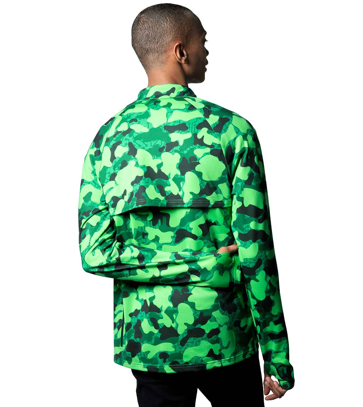 A person with short hair, wearing the GREEN-CAMO CASUAL JACKET from Machina - Wearable Technology, stands facing away from the camera. This stylish jacket is made from sustainable fabrics, showcases a high collar and offers a relaxed fit against a plain white background.
