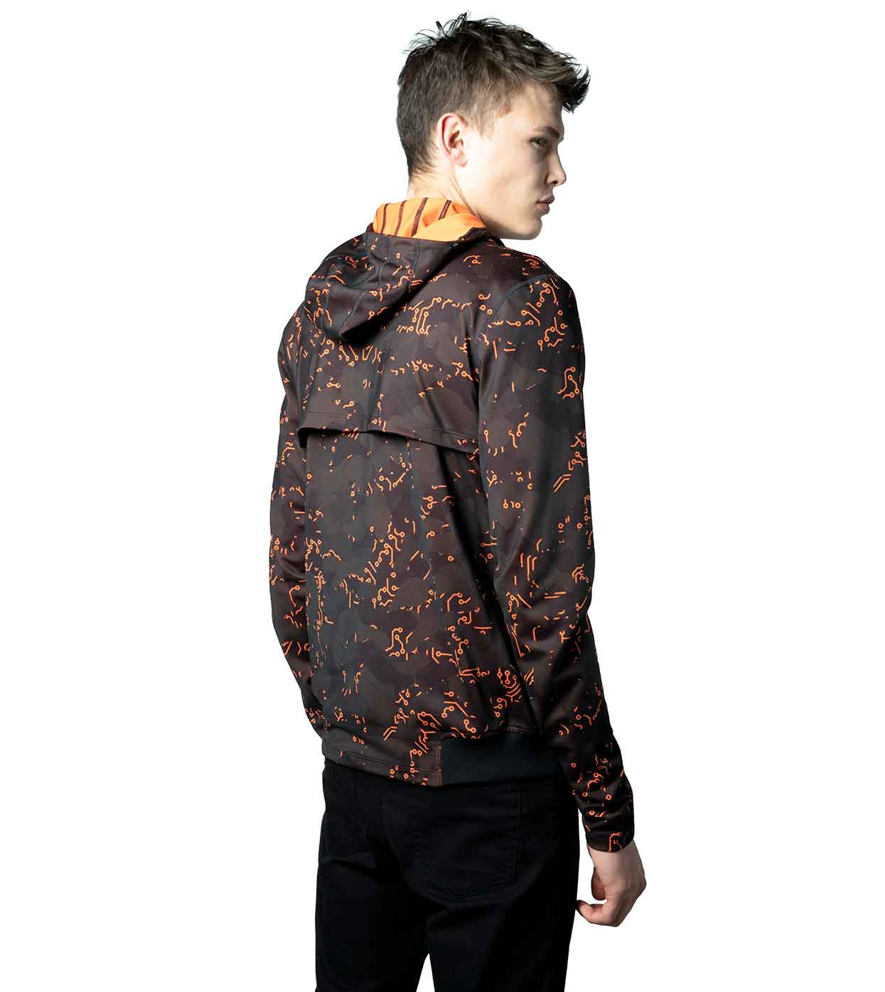 The ELECTRIC ORANGE HOODIE by Machina - Wearable Technology is showcased on a person turned away from the camera, displaying its signature black design with waterproof zippers and vibrant orange abstract pattern. This innovative fashion tech garment includes a hood and is set against a simple white background.