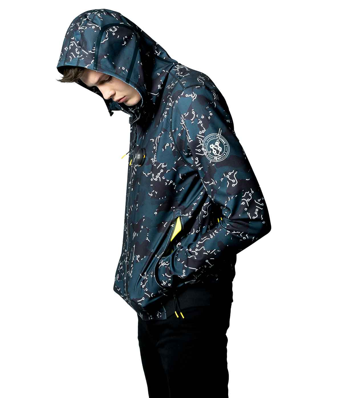 A person wearing an ELECTRIC WHITE HOODIE by Machina - Wearable Technology, featuring a dark, abstract design, stands in side profile against a white background. The hood is up, partially covering the face and seamlessly blending fashion and technology into its sleek appearance.