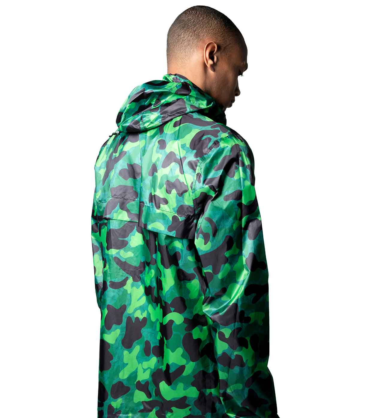An individual is seen from behind, wearing the AQUA-CAMO WINDBREAKER by Machina - Wearable Technology, featuring green and black camouflage with aqua shades, set against a plain white background.